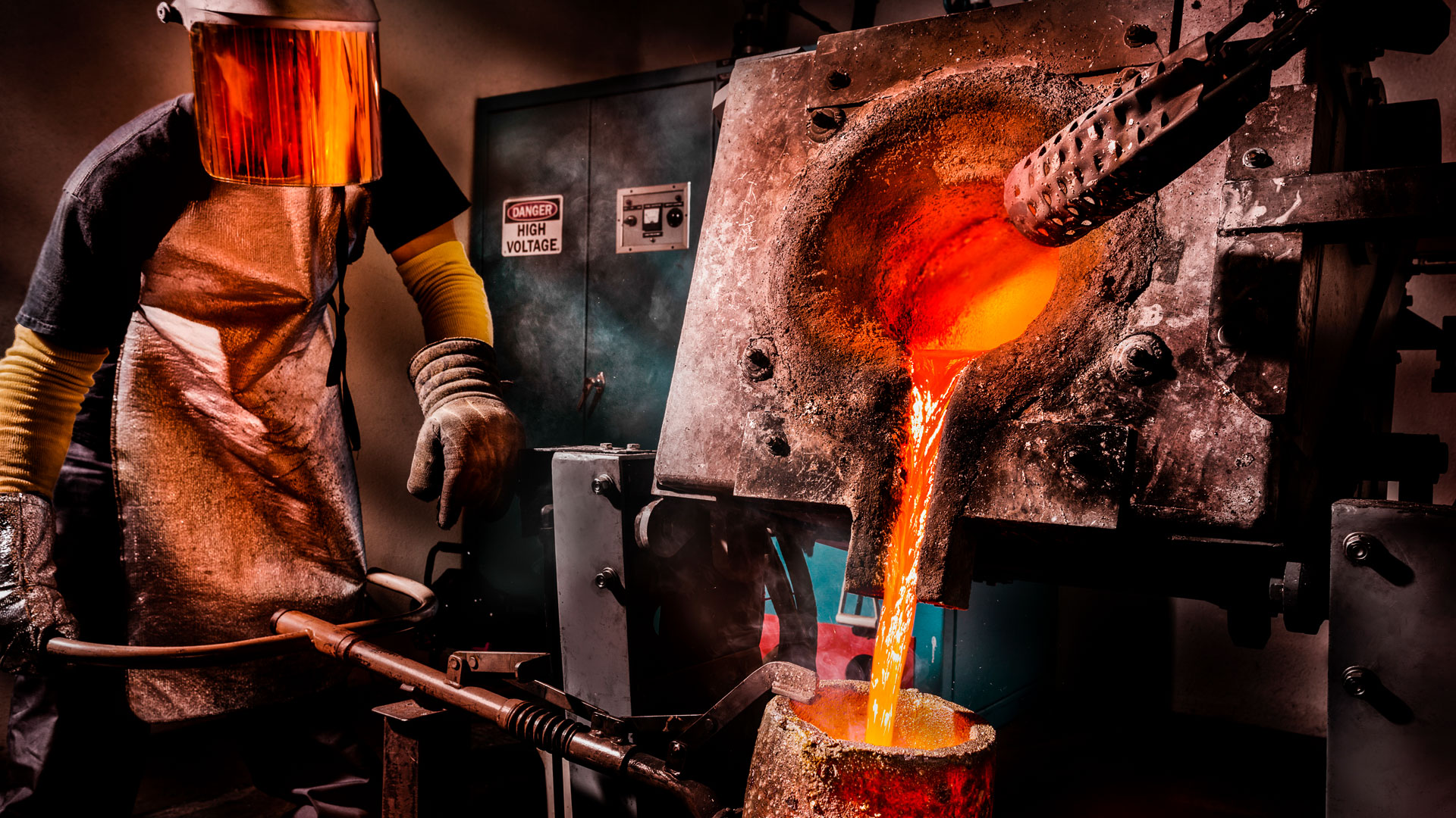 Worker pouring liquid metal into crucible